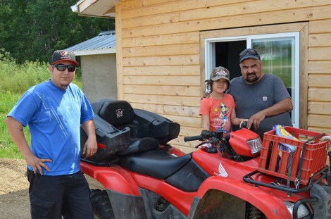 Jack Lynis with family members outside of pizzeria under construction